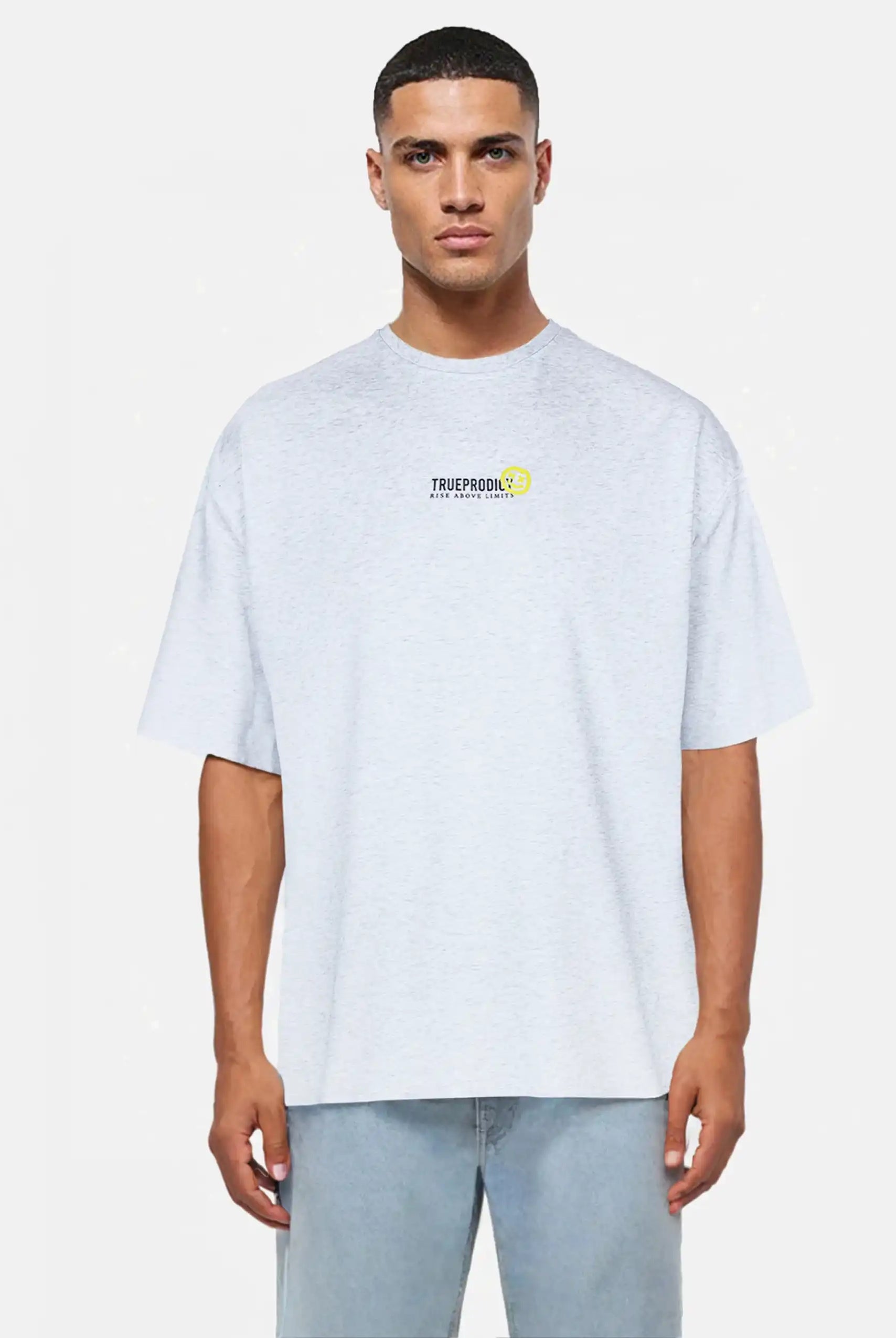 Ein Mann steht mit Blick nach vorne und trägt ein hellgraues trueprodigy Oversize-Herren-T-Shirt mit Logo-Smile-Grafik auf der Brust, gepaart mit hellblauen Jeans, vor einem schlichten hellen Hintergrund.