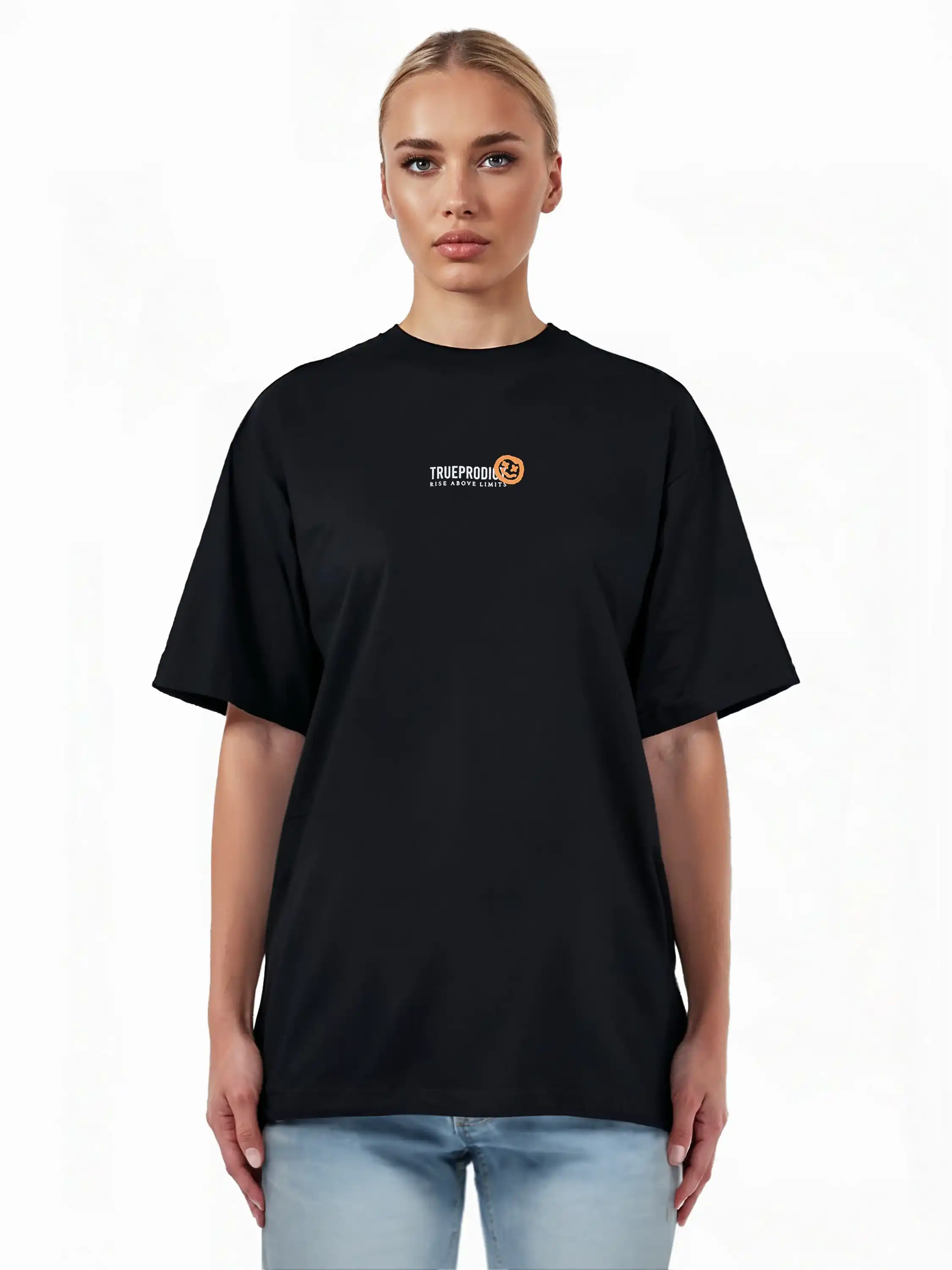 Eine Person steht mit dem Gesicht nach vorne in einem lockeren Juniper F Oversize-Damen-T-Shirt von trueprodigy, das auf der Vorderseite eine Logo-Smile-Grafik zeigt. Der Hintergrund ist einfarbig weiß und sie trägt außerdem eine hellblaue Jeans.