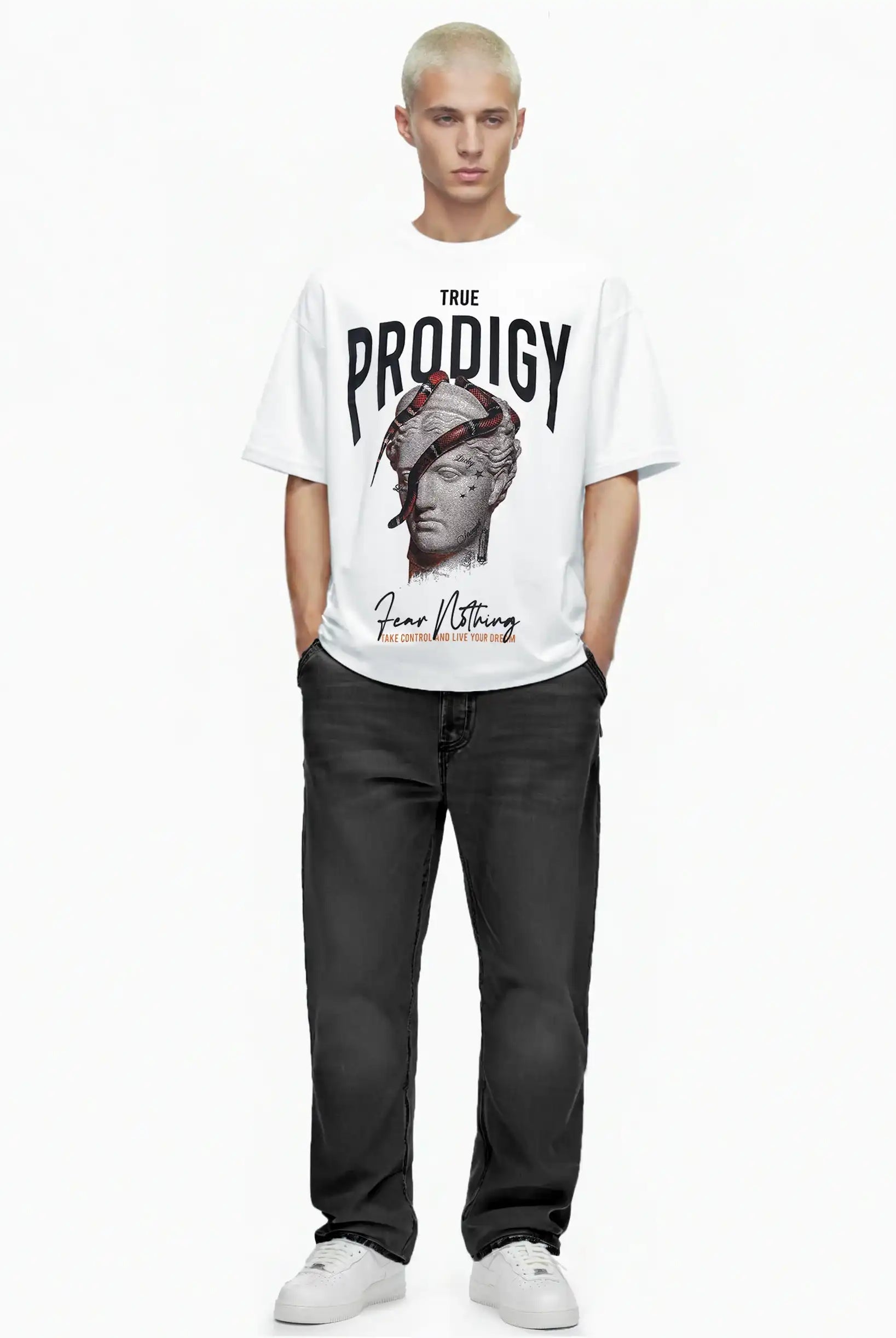 Eine Person mit kurzen blonden Haaren blickt nach vorne in einem trueprodigy Jamie Oversize-T-Shirt mit Skulptur-Grafik, Schlange & "Fear Nothing"-Print, gepaart mit schwarzen Jeans und weißen Turnschuhen, vor einem schlichten weißen Hintergrund.