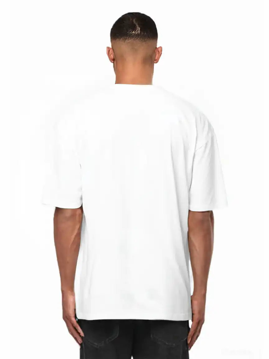 Ein Mann schaut von der Kamera weg und trägt das trueprodigy Nika Oversize-Basicshirt mit TPDY-Stickerei & klarer Silhouette in weiß und dunkler Hose. Der Hintergrund ist einfarbig weiß.